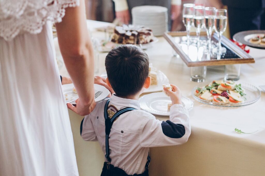 llittle boy sampling snacks keeping kids happy at weddings