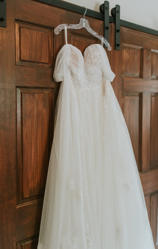 image of wedding dress hanging on closet at destination wedding