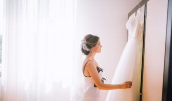 bride lovingly looking at her gown after travelling with her wedding dress