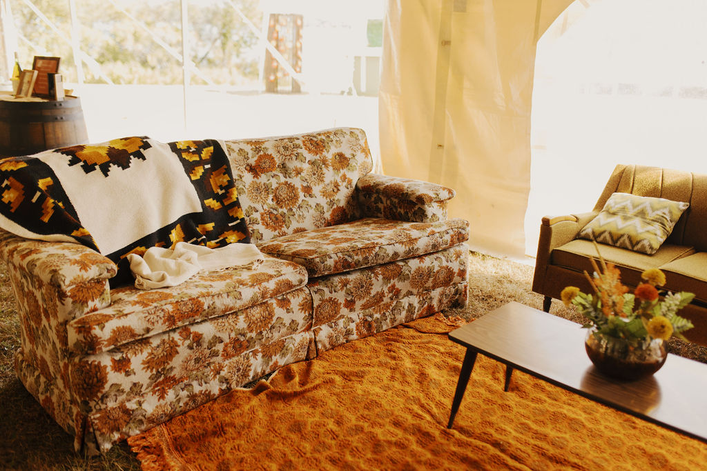70s-inpired wedding lounge area with floral couch