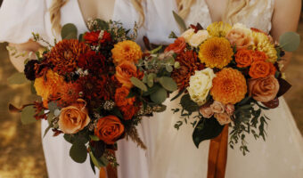 two brides with beautiful fall wedding flowers bouquets