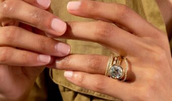 womans hand wearing the top engagement ring trends