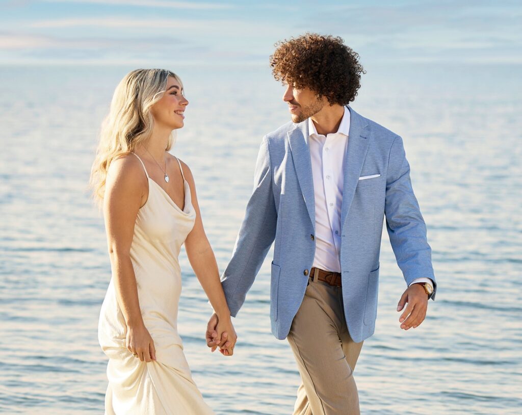groom and bride walking on the beach holding hands at destination wedding