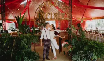 summer wedding entertainment circus wedding bride and groom kissing inside tent
