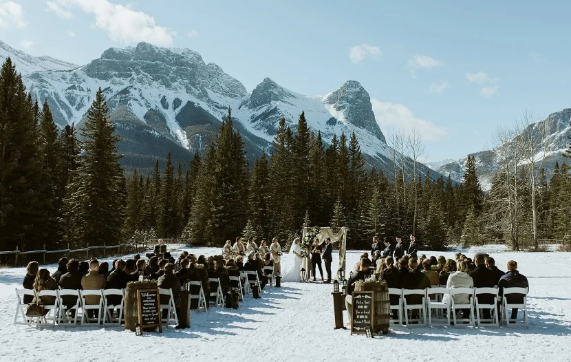 Picturesque scene of a couple amidst breathtaking natural scenery during a winter wedding in Canmore, 