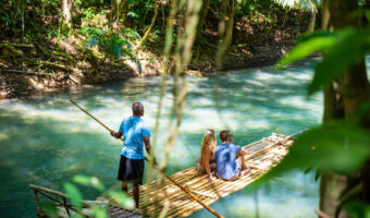 Couple rafting down Martha Brae River on Jamaica honeymoon