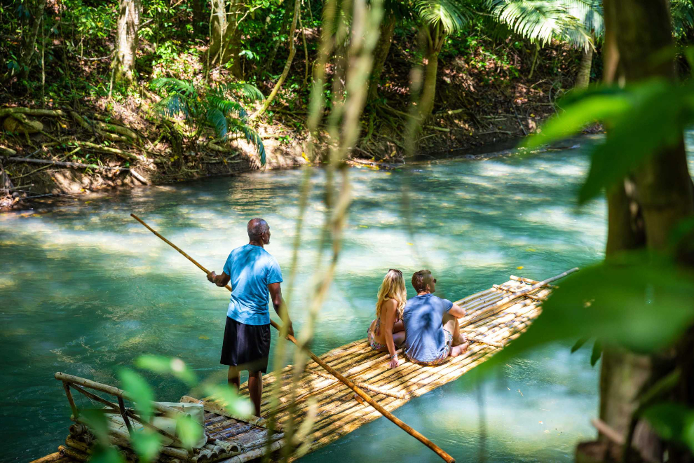 Couple rafting down Martha Brae River on Jamaica honeymoon