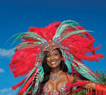 Jamaica carnival a honeymoon experience unlike any other. Beautiful black woman wearing carnival costume with feather headdress