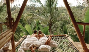 newlyweds hammock balcony of bamboo tree house with jungle nature view. Vacation in beautiful hidden place, honeymoons on Bali island