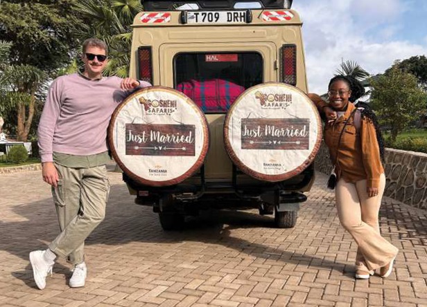 Leo and zuri standing by Safari Jeep