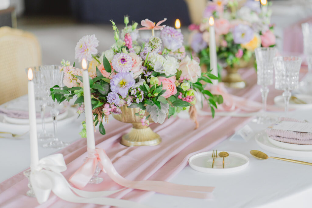 romantic wedding table with pastel flowers and greenery candlelight styled shoot