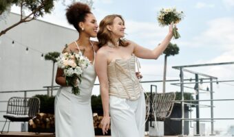 two brides smile at guests during surprise wedding