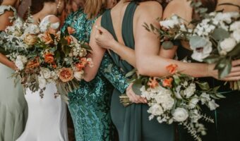 ladies wear bridesmaid dress in shades of green for portrait with bride