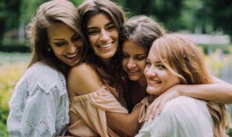 bride and bridesmaids hug while at bachelorette wellness retreat