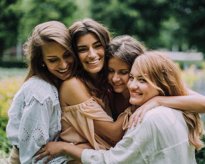 bride and bridesmaids hug while at bachelorette wellness retreat