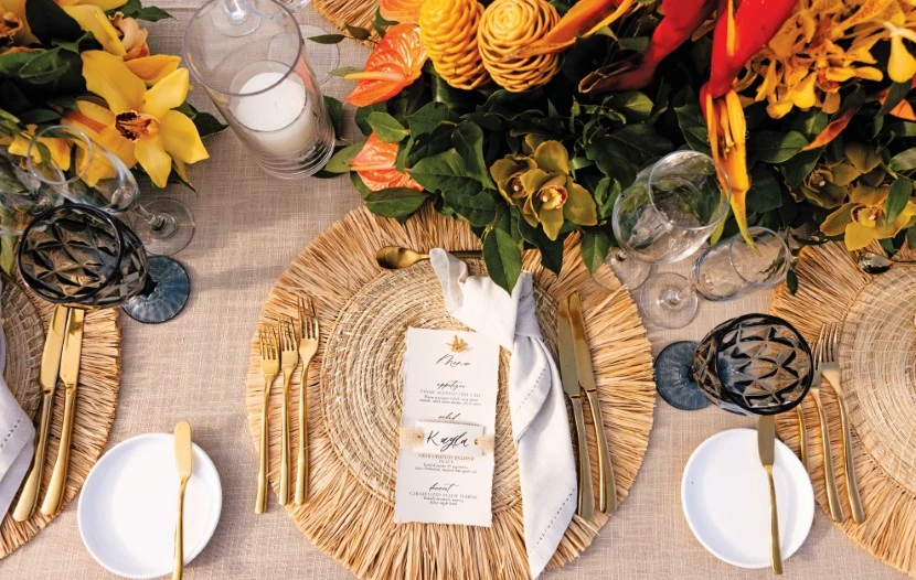 An exquisite table setting adorned with striking gold and orange flowers, creating a warm and inviting atmosphere