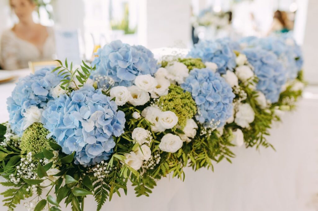 gorgeous hydrangea table runner with greenery and white flowers beautiful spring wedding flowers