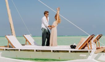 Zanzibar, Mjini Magharibi Region, Tanzania Romantic Couple on Dhow in Zanzibar's Turquoise Waters