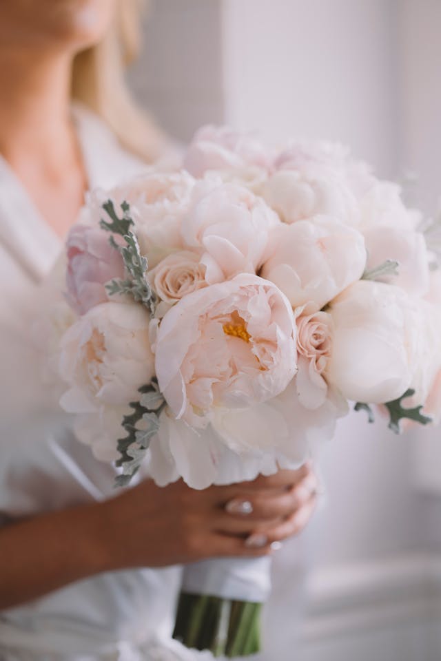 bride with blooming peony bouquet on wedding day