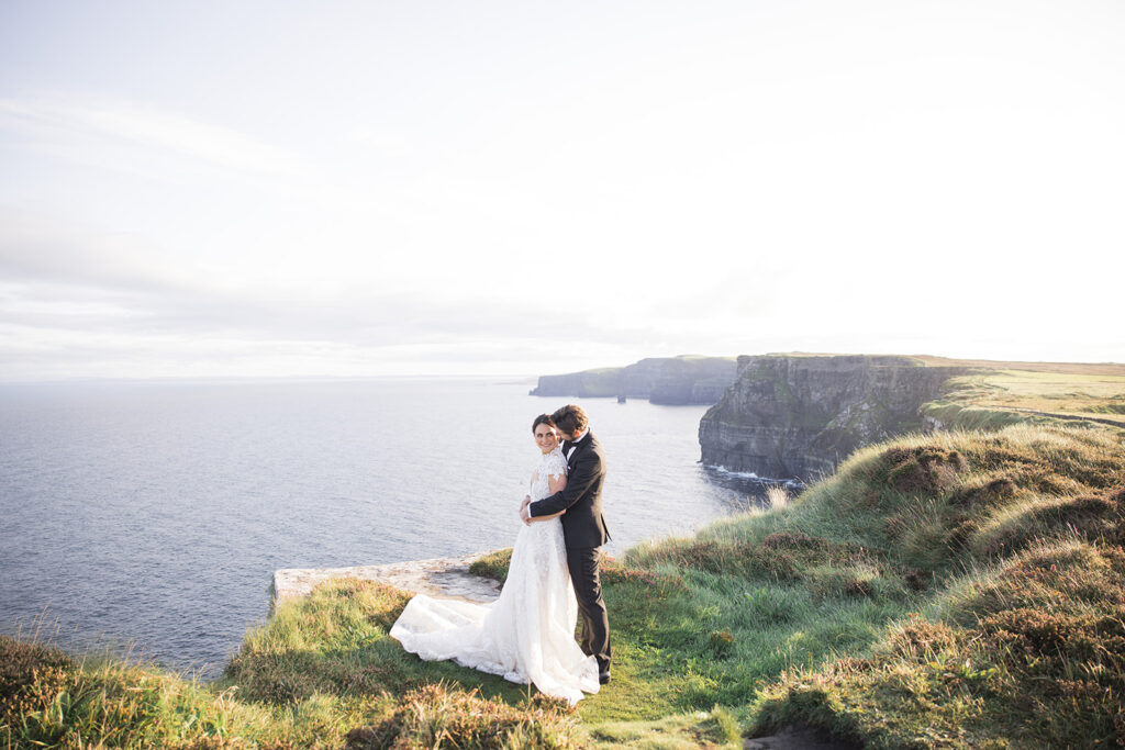 dramatic cliff wedding portrait overlooking majestic ocean at the Cliffs of Moher