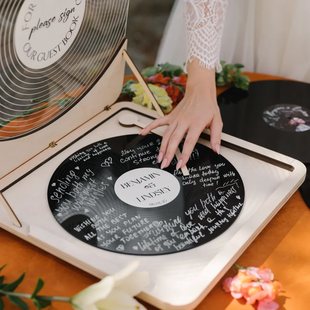 bride with hand on vinyl record wedding guestbook turntable