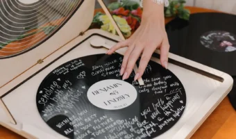 bride with hand on vinyl record wedding guestbook turntable
