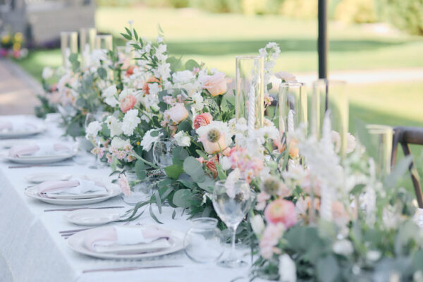 beautiful wedding flowers on reception table at romantic garden wedding