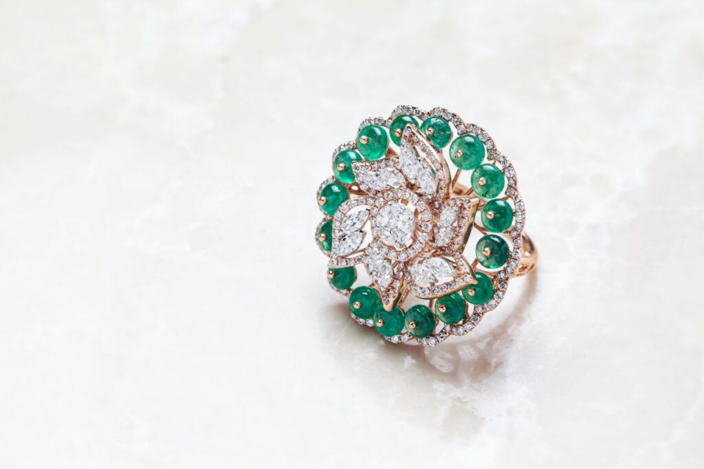 gorgeous round vintage engagement ring with emeralds and diamonds 