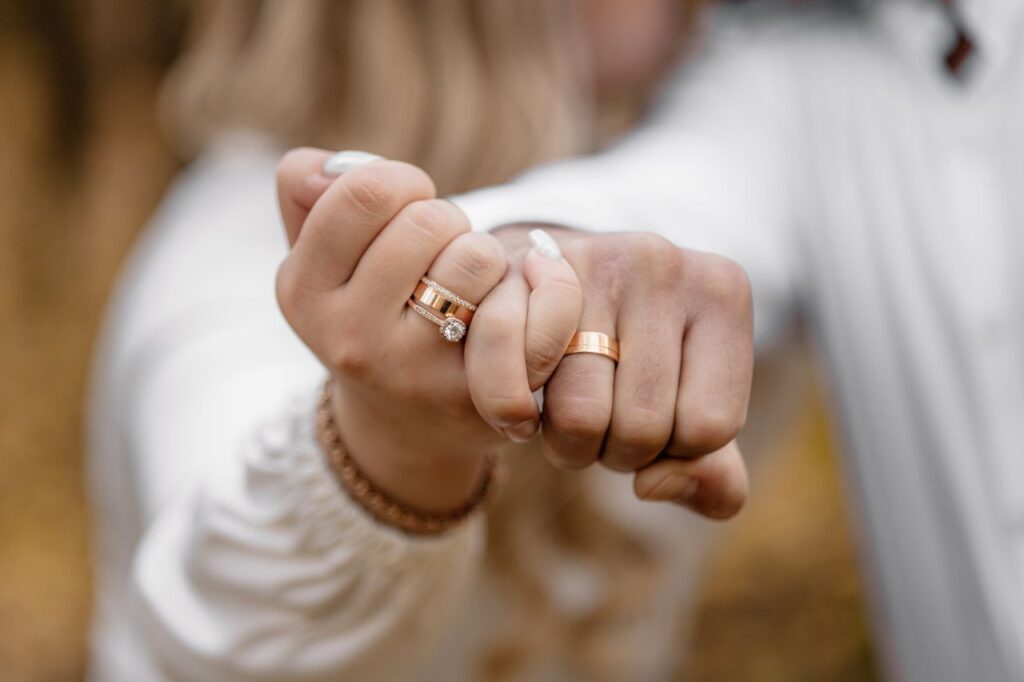 man and woman wearing white interlock fingers for engagement ring photo