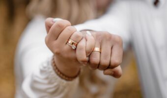 man and woman wearing white interlock fingers for engagement ring photo