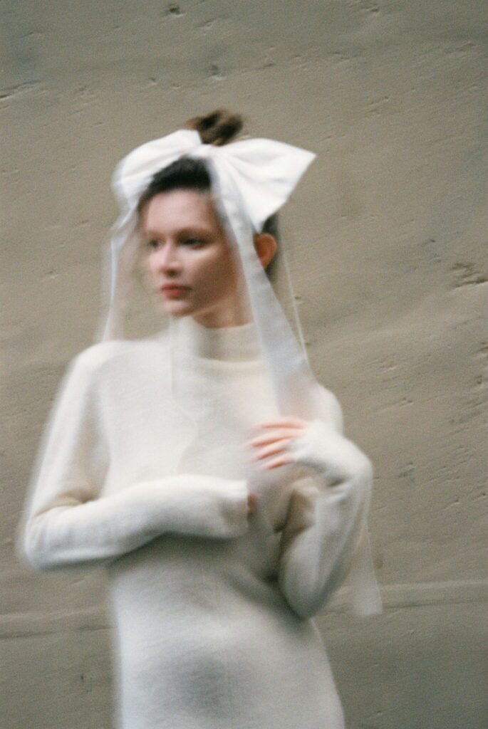 blurred action wedding images 2025 wedding photography trends bride wearing oversized bow in hair blurred wedding image