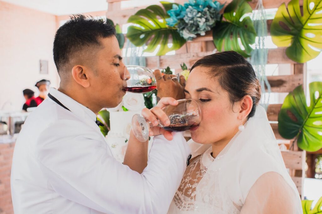 bride and groom interlock arms and drink their unity wine