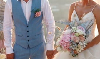 Happy bride and groom holding hands on wedding ceremony, copy space. Wedding couple in love, newlyweds. bridal bouquet summer weddings