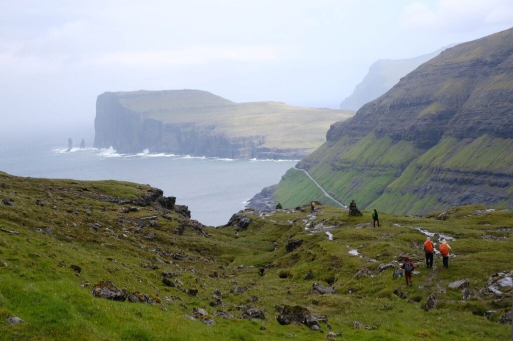couple hiking in Faroe Islands with incredible views