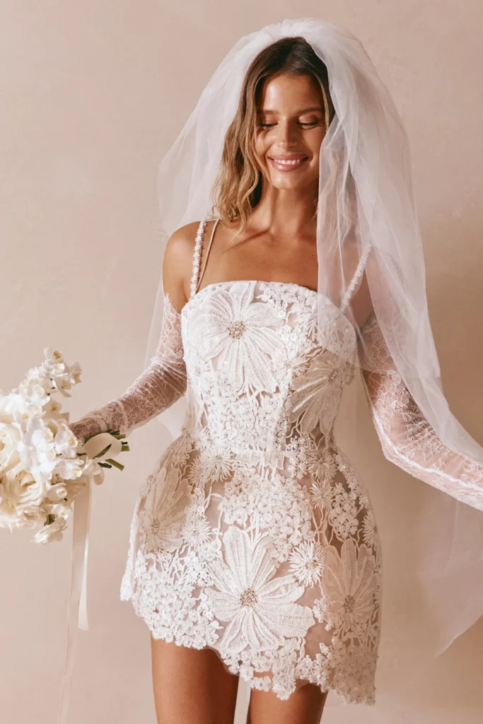 pretty woman in sassy short floral wedding dress with two layer wedding veil fingertip length and elbow length layers