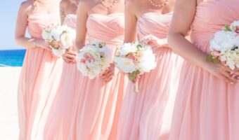 bridesmaids wearing pink on beach cost to be a bridesmaid
