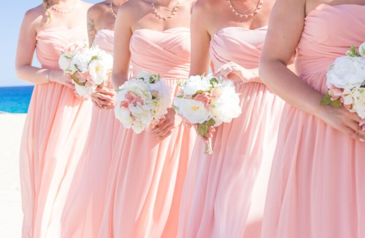 bridesmaids wearing pink on beach cost to be a bridesmaid