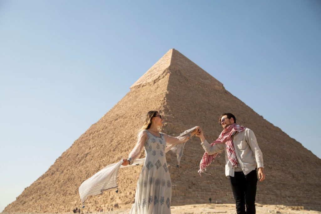 couple dances in front of Giza pyramid on non-traditional honeymoon destinations