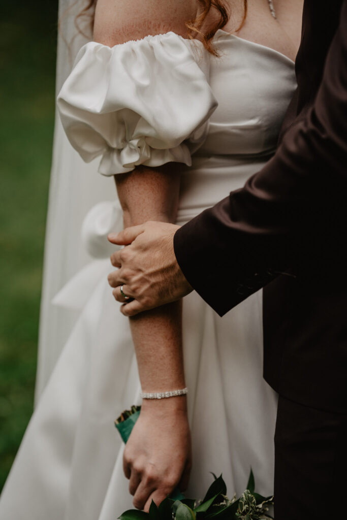 bride wearing silk wedding dress with removable sleeves the perfect wedding dress accessories