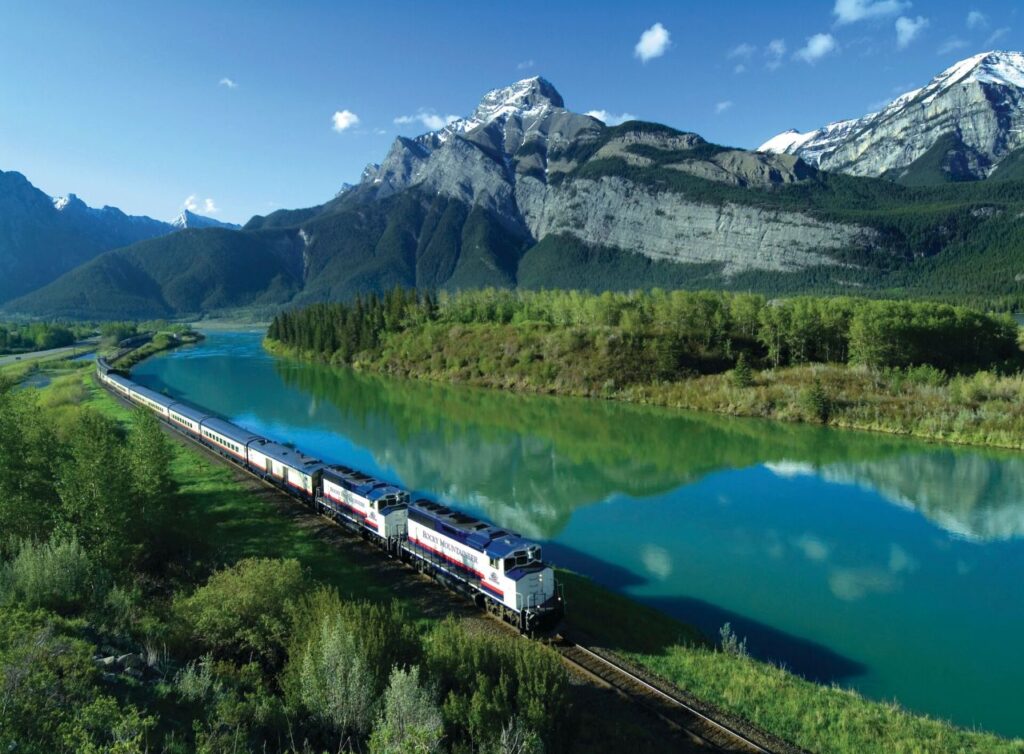 Rocky Mountaineer luxury train along beautiful mountain lake for solo bachelorette experience