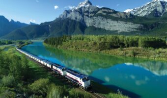 Rocky Mountaineer luxury train along beautiful mountain lake for solo bachelorette experience