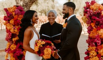 African American couple at altar with wedding officiant reciting vows
