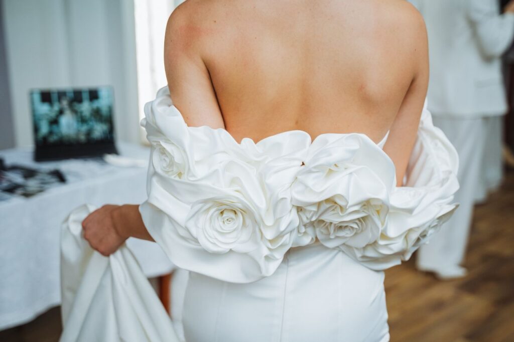 bride wearing detachable wrap with large rosette design the most beautiful wedding dress accessories