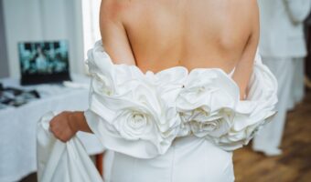 bride wearing detachable wrap with large rosette design the most beautiful wedding dress accessories