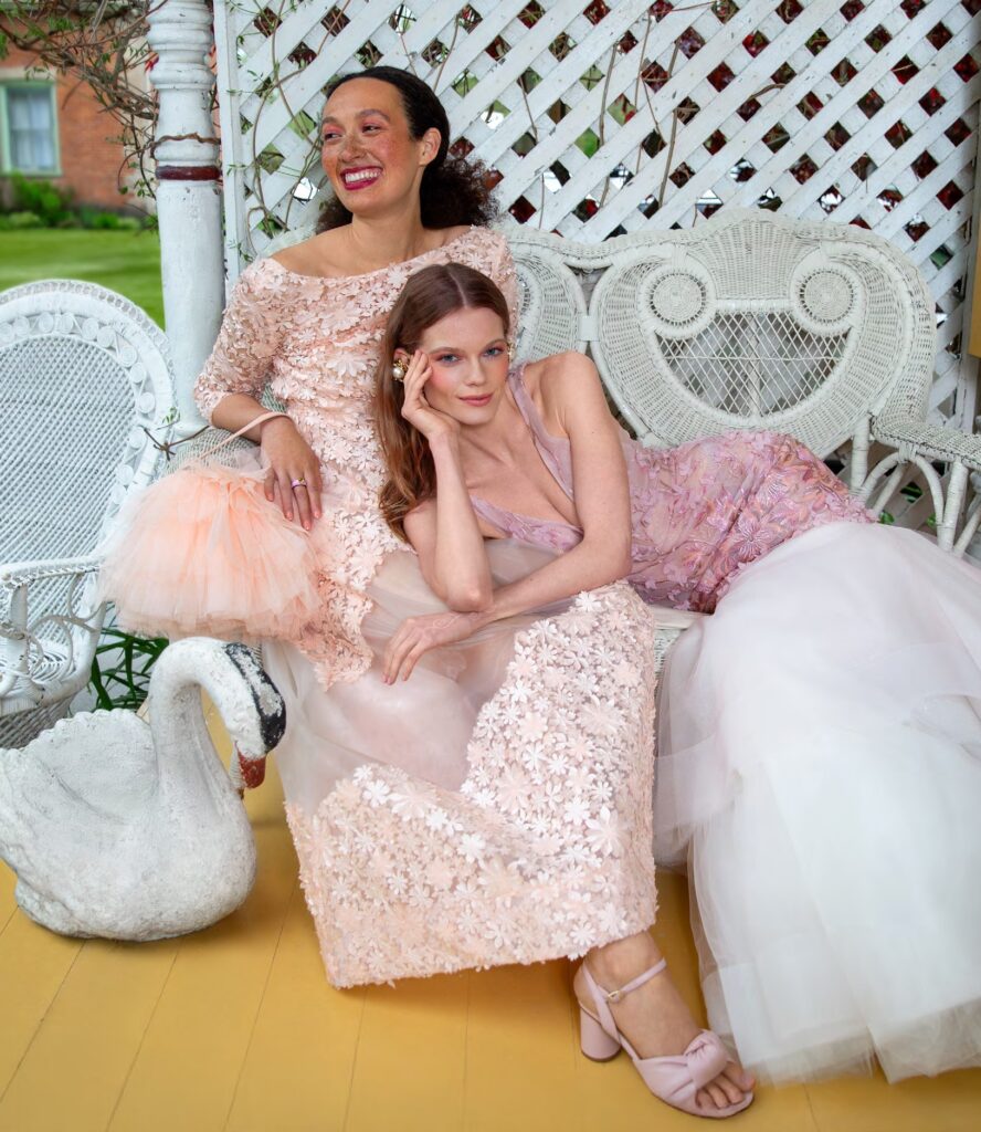 two models wearing blush gowns 