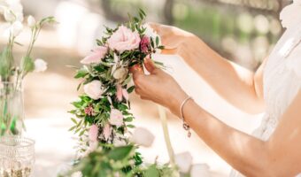 pretty wedding florist creating wedding flower garland