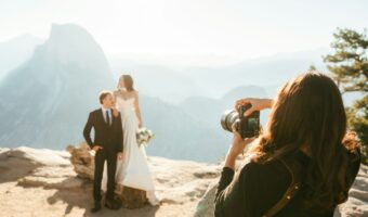newlyweds pose for portrait next to canyon in the mountains wedding tips