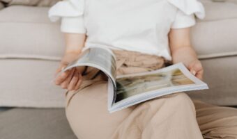 woman sitting on floor reading Spring/Summer 2026 issue of Today's Bride wedding magazine