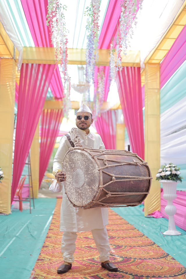 Pink gold and turquoise wedding aisle with Indian wedding drummer cultural wedding music