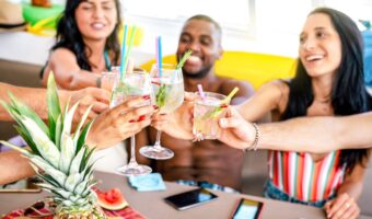 friends toast in celebration on boat for wedding rehearsal dinners